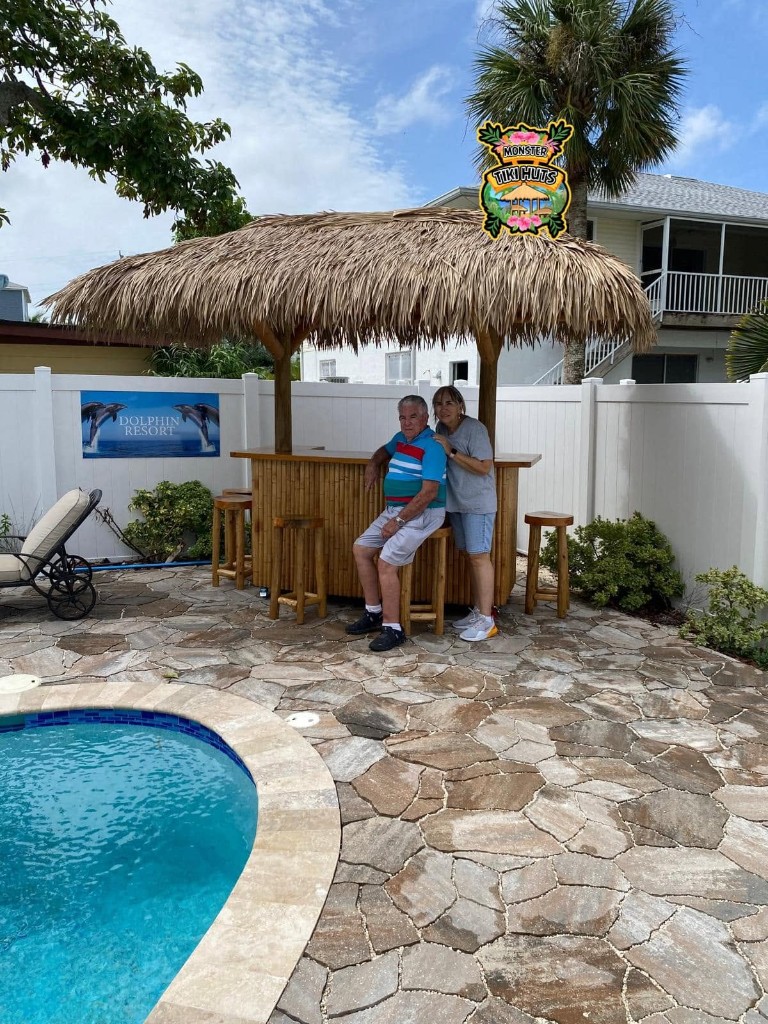 Backyard pool tiki bar with synthetic thatch