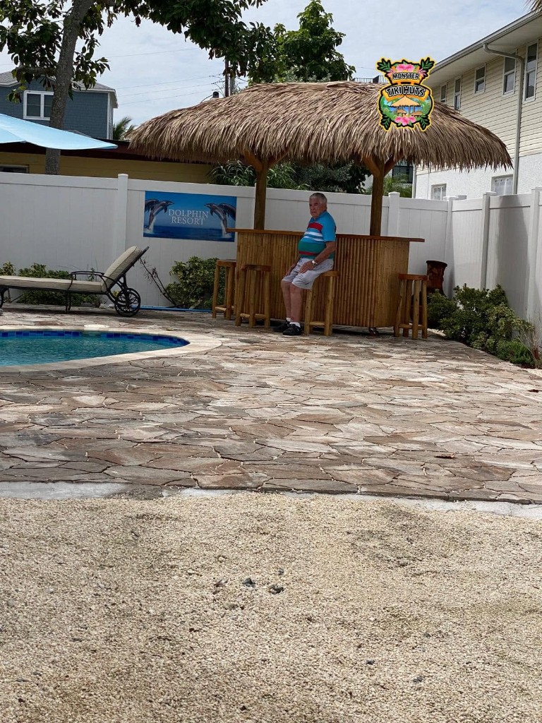 Backyard tiki bar with synthetic thatch roofing