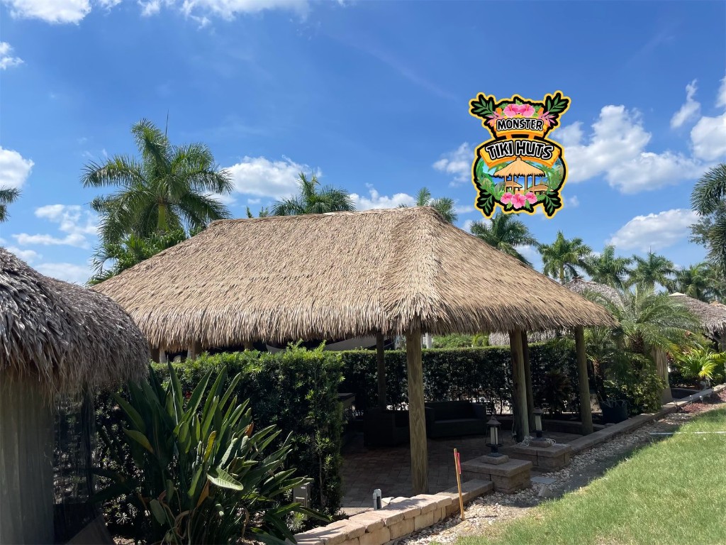 Large tiki hut with synthetic thatch hip roof
