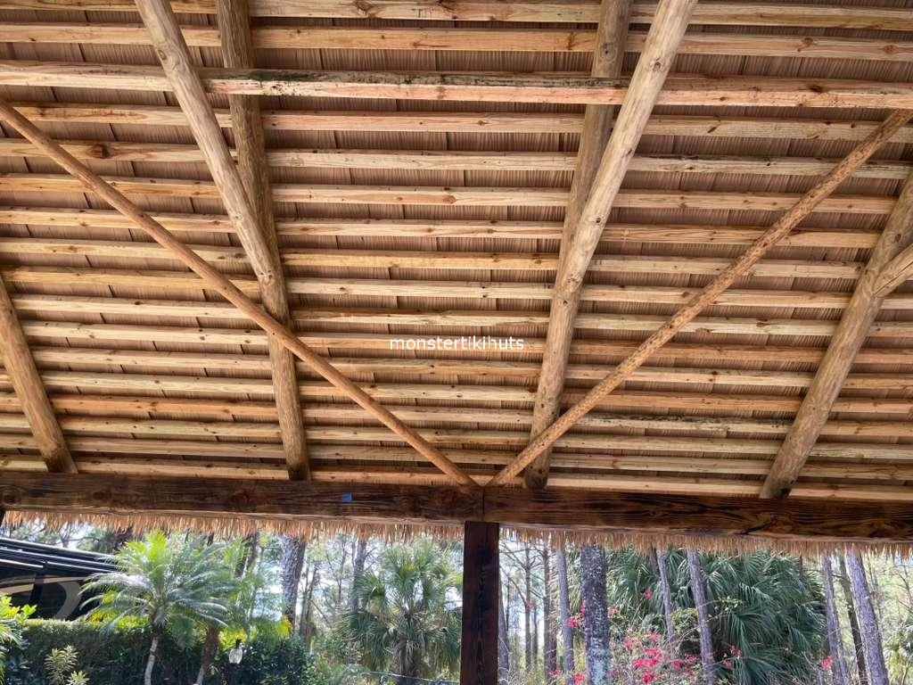 Synthetic thatch folded interior with tropical landscaping