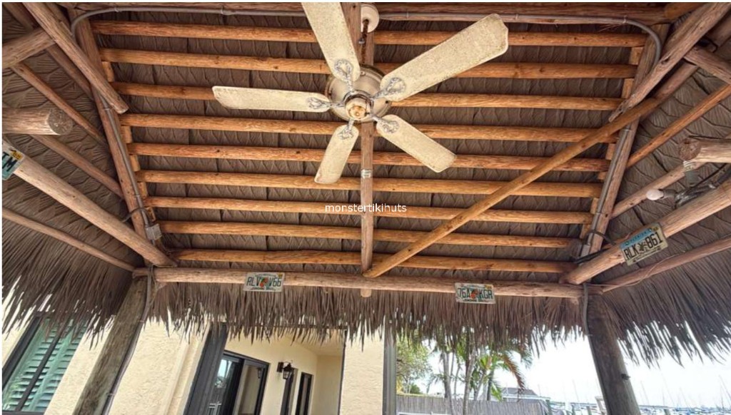 Synthetic thatch interior with ceiling fan and license plate decor